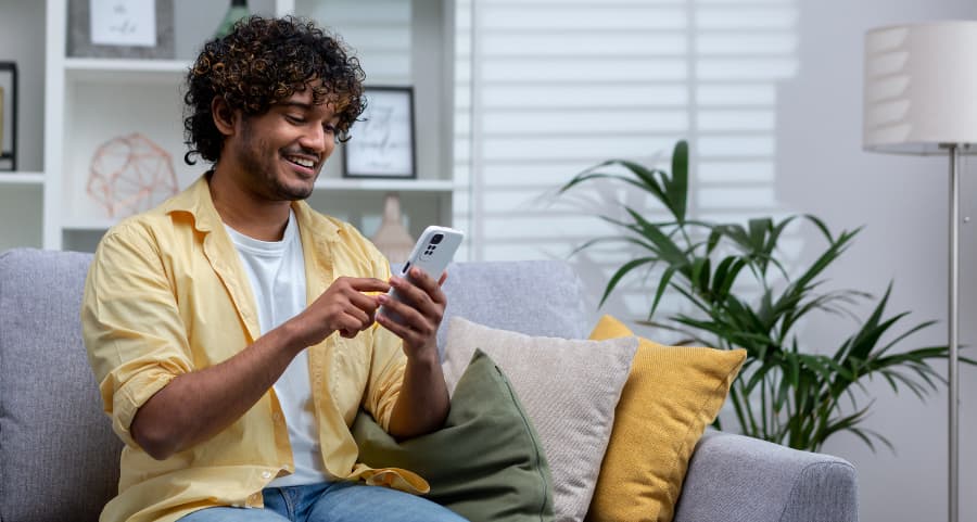 Man navigating a home security app on his mobile device